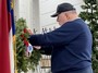 Commander Ed McCloskey places the Marine wreath.